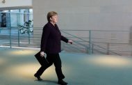 Germany's Merkel returns to office after quarantine stint